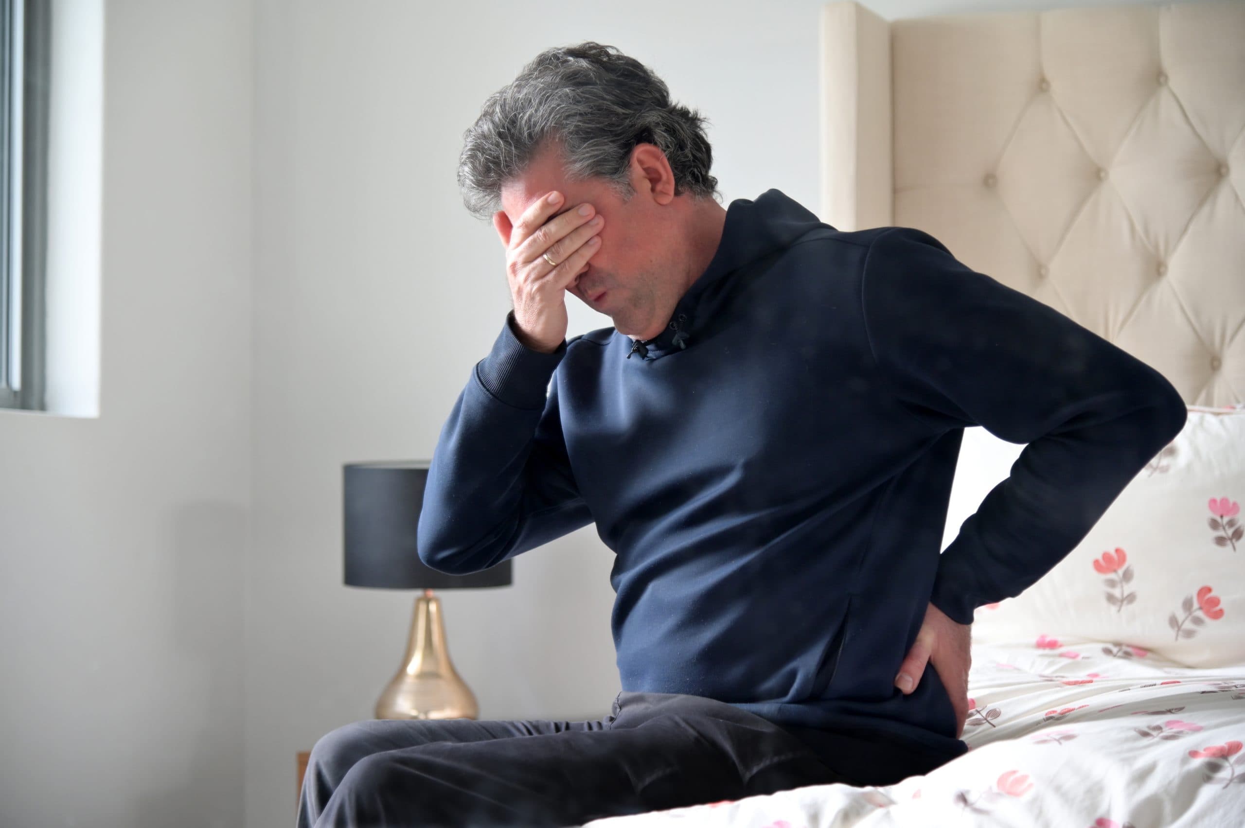 Man with hip pain at home